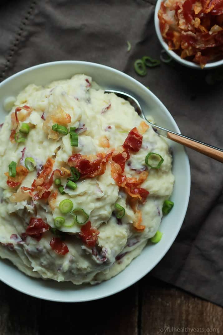 A Bowl of Horseradish Mashed Potatoes Beside a Small Dish of Pancetta