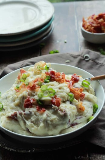 A Bowl of Mashed Potatoes Next to a Stack of Plates and Additional Pancetta