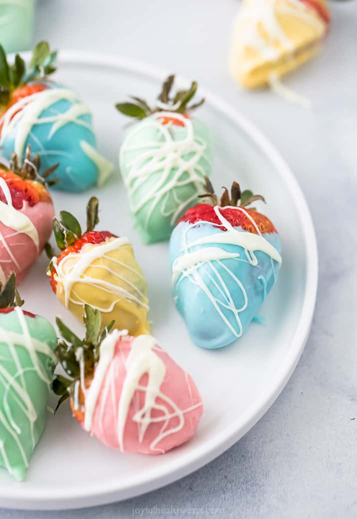 close up of easter egg chocolate covered strawberries on a plate