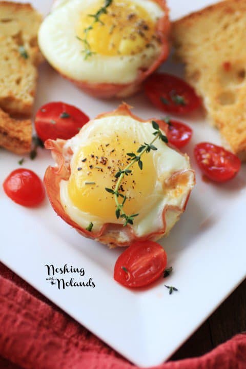 A Ham and Egg Cup Surrounded by Halved Cherry Tomatoes