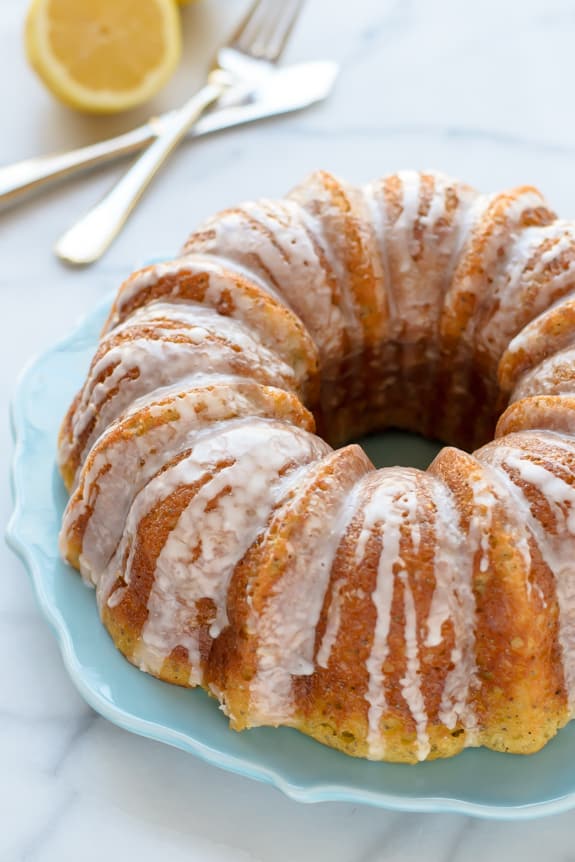 A Lemon Poppyseed Cake Drizzled with Lemon Glaze on a Serving Plate