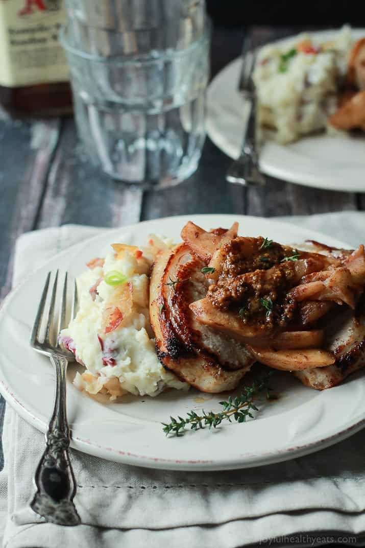 Pork Chops, Glazed Apples and Mashed Potatoes on a Plate with a Fork