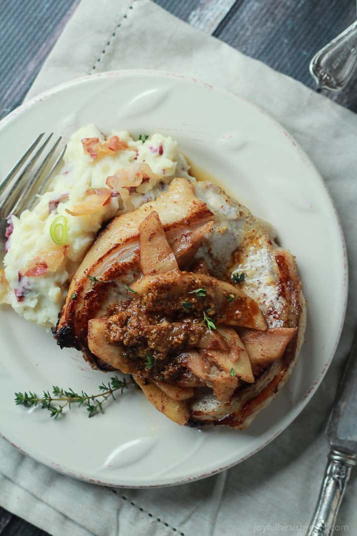 A Plate of Pork Chops and Glazed Apples with Loaded Mashed Potatoes on the Side