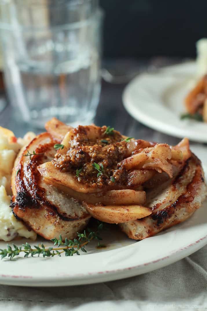 A Close-Up Shot of Mustard Crusted Pork Chops and Bourbon Glazed Apples on a Plate