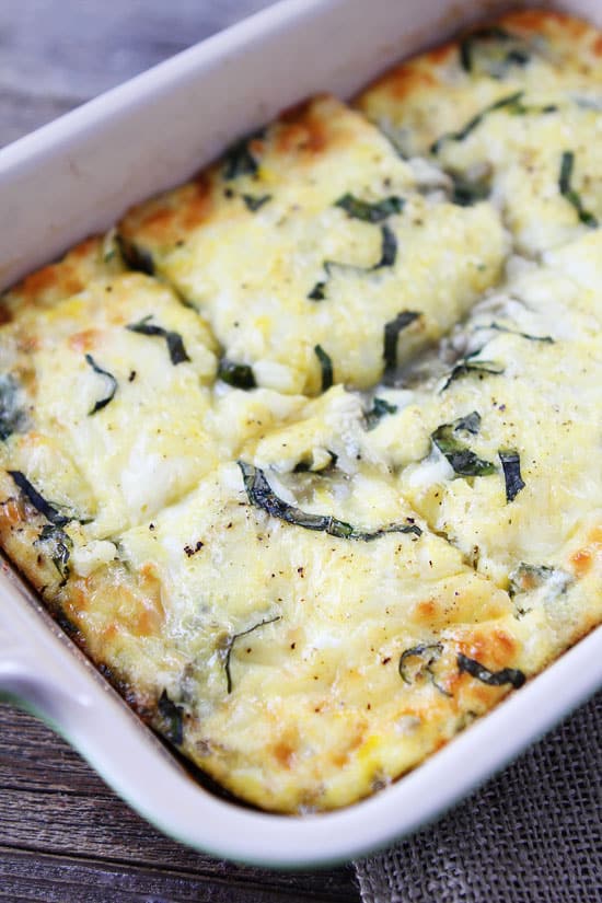 A Spinach and Artichoke Egg Casserole in a White Pan