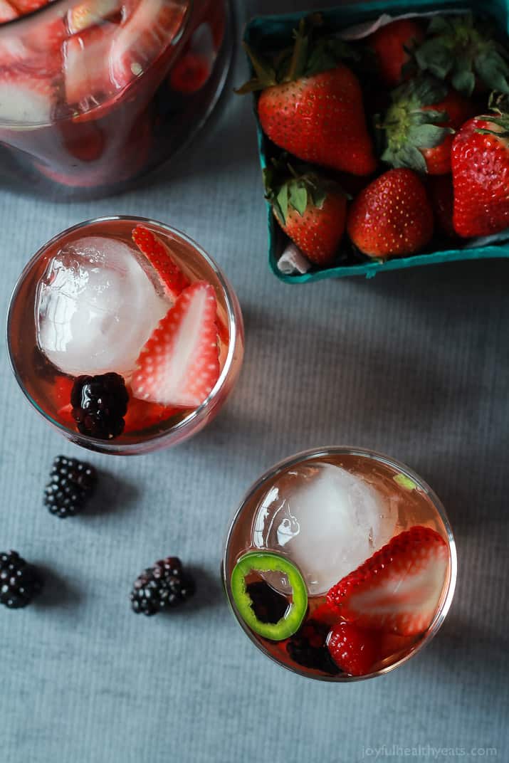 A fresh light Strawberry Jalapeno White Sangria recipe with pomegranate juice and mixed berries. It has everything your taste buds want sweet, spicy ,and fruity! | joyfulhealthyeats.com #recipes #cocktail