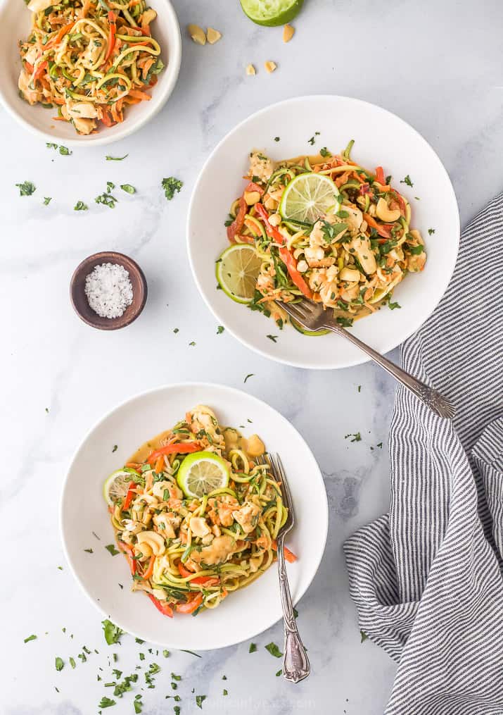 overhead photo of thai chicken zucchini noodles with spicy peanut sauce in a bowls