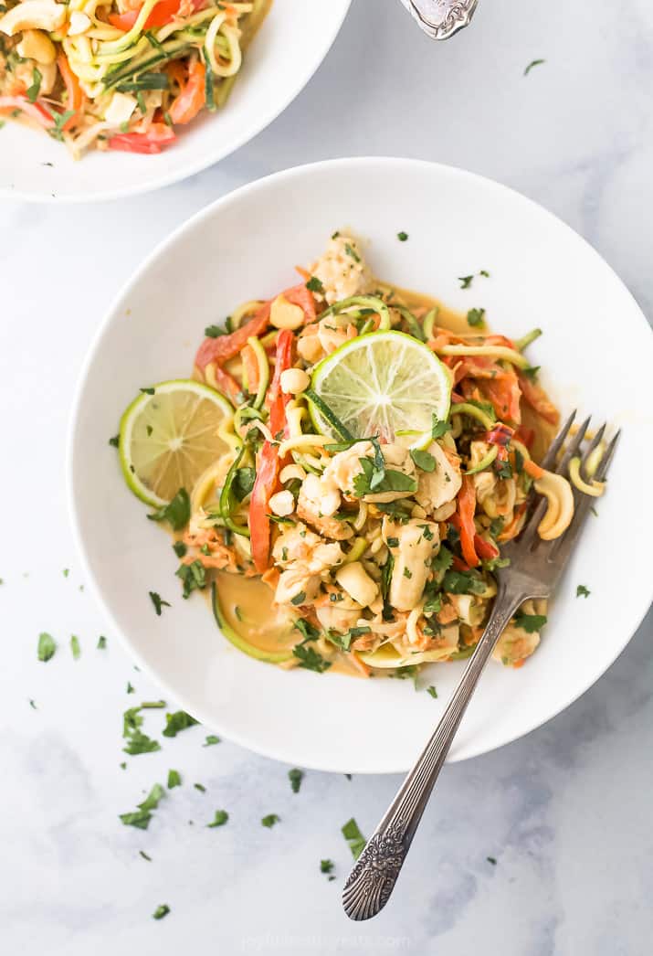 thai chicken zucchini noodles with spicy peanut sauce in a bowl