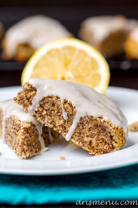 Two Lemon Zest Scones on a Plate with a Lemon
