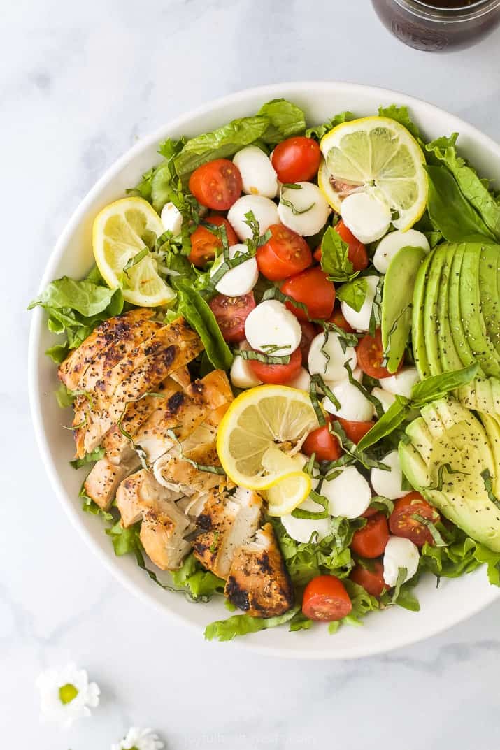 overhead photo of avocado caprese chicken salad in a bowl