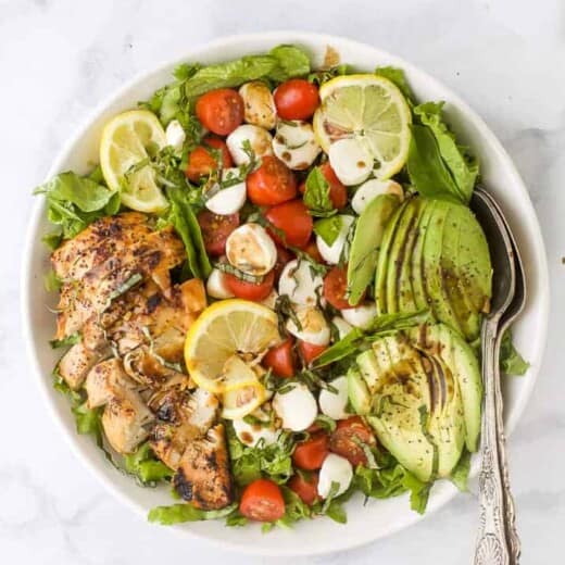 overhead photo of avocado caprese chicken salad with balsamic vinaigrette