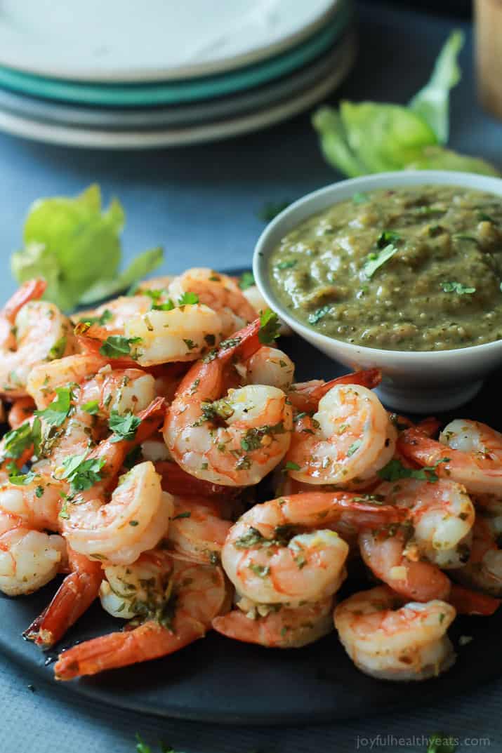 Cilantro Lime Roasted Shrimp on a plate with a cup of homemade Roasted Tomatillo Sauce