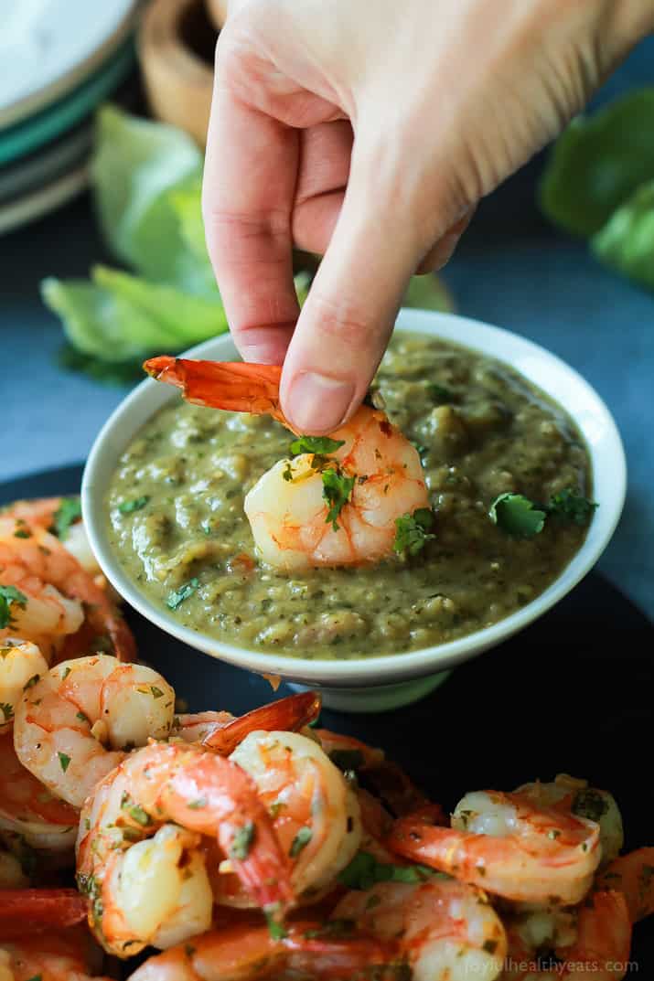 Cilantro Lime Roasted Shrimp being dipped into roasted tomatillo sauce