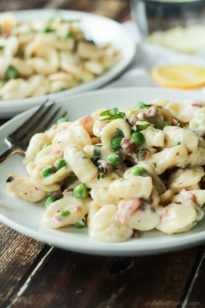 Crispy Pancetta Sweet Pea Orecchiette Pasta tossed with a creamy lemon herb Goat Cheese Sauce! This pasta recipe is comfort food to the max AND its skinny! | joyfulhealthyeats.com #recipes 