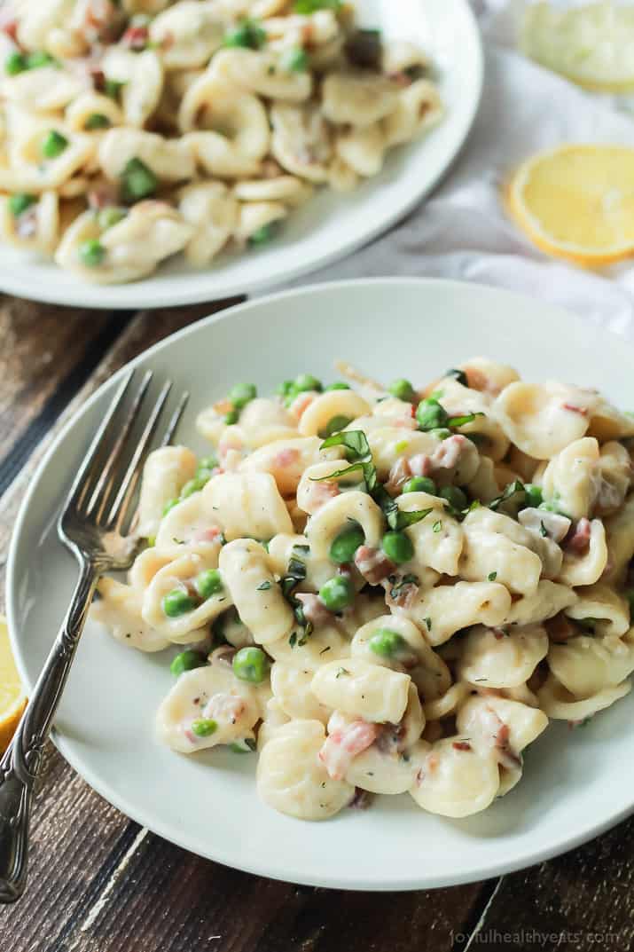 Crispy Pancetta Sweet Pea Orecchiette Pasta tossed with a creamy lemon herb Goat Cheese Sauce! This pasta recipe is comfort food to the max AND its skinny! | joyfulhealthyeats.com #recipes 