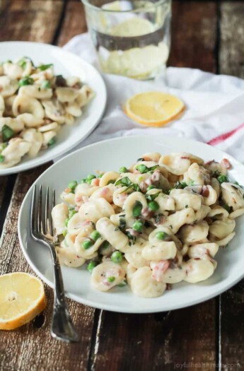 Crispy Pancetta Sweet Pea Orecchiette Pasta tossed with a creamy lemon herb Goat Cheese Sauce! This pasta recipe is comfort food to the max AND its skinny! | joyfulhealthyeats.com #recipes