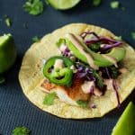 The BEST Grilled Mahi Mahi Fish Tacos you will ever have. Topped with crunchy purple cabbage, avocados, and a drizzle of Chipotle Lime Crema - all wrapped in a warm tortilla! All in under 20 minutes! | joyfulhealthyeats.com #recipes #grillseason