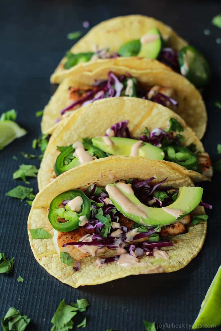 The BEST Grilled Mahi Mahi Fish Tacos you will ever have. Topped with crunchy purple cabbage, avocados, and a drizzle of Chipotle Lime Crema - all wrapped in a warm tortilla! All in under 20 minutes! | joyfulhealthyeats.com #recipes #grillseason