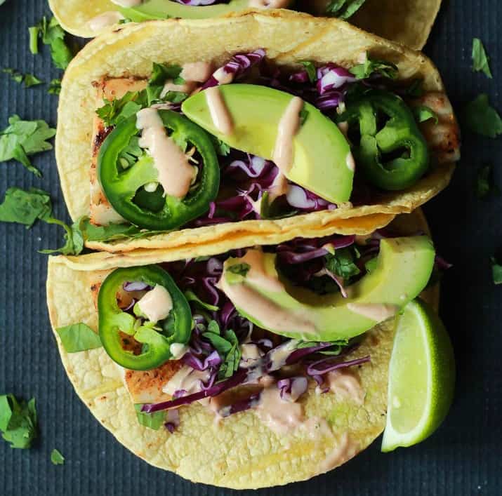 The BEST Grilled Mahi Mahi Fish Tacos you will ever have. Topped with crunchy purple cabbage, avocados, and a drizzle of Chipotle Lime Crema - all wrapped in a warm tortilla! All in under 20 minutes! | joyfulhealthyeats.com #recipes #grillseason