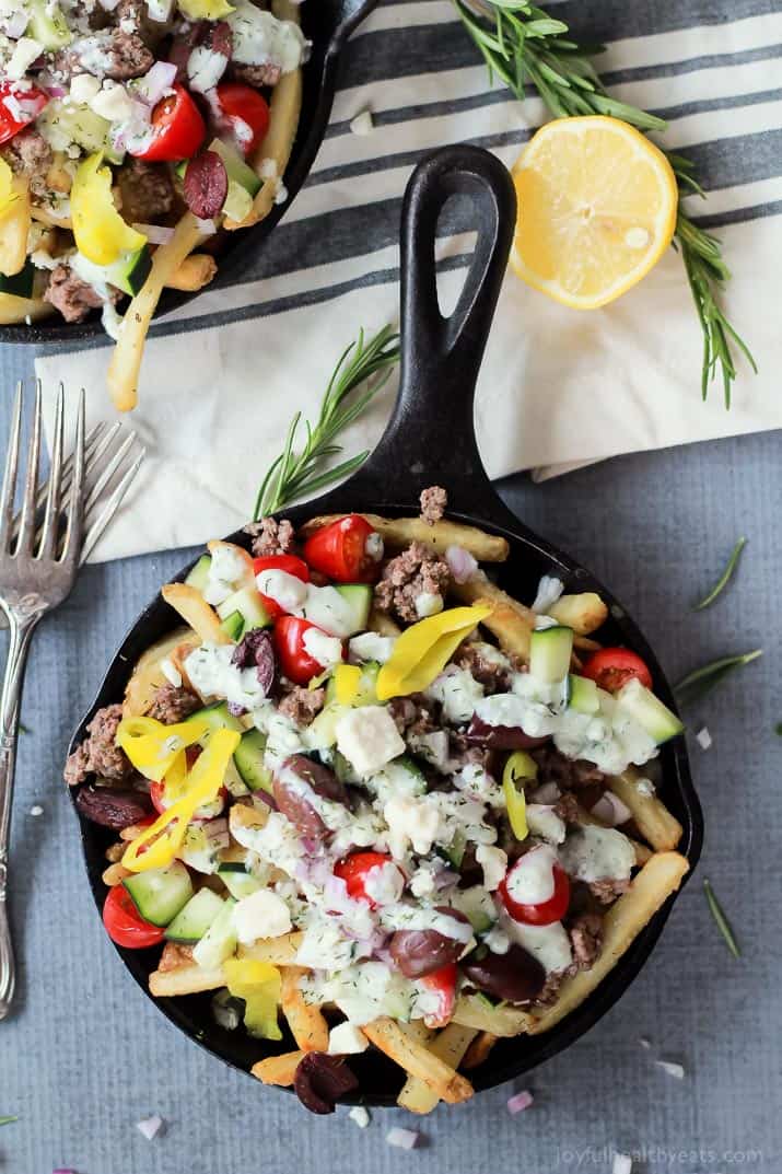 Skinny Greek Loaded French Fry Nachos, an easy creative appetizer recipe that will wow your guests and only takes 25 minutes to make! Filled with homemade tzatziki sauce, ground lamb, and fresh vegetables! | joyfulhealthyeats.com #recipes #SpringIntoFlavor #ad