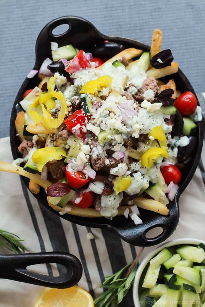 Skinny Greek Loaded French Fry Nachos, an easy creative appetizer recipe that will wow your guests and only takes 25 minutes to make! Filled with homemade tzatziki sauce, ground lamb, and fresh vegetables! | joyfulhealthyeats.com #recipes #SpringIntoFlavor #ad