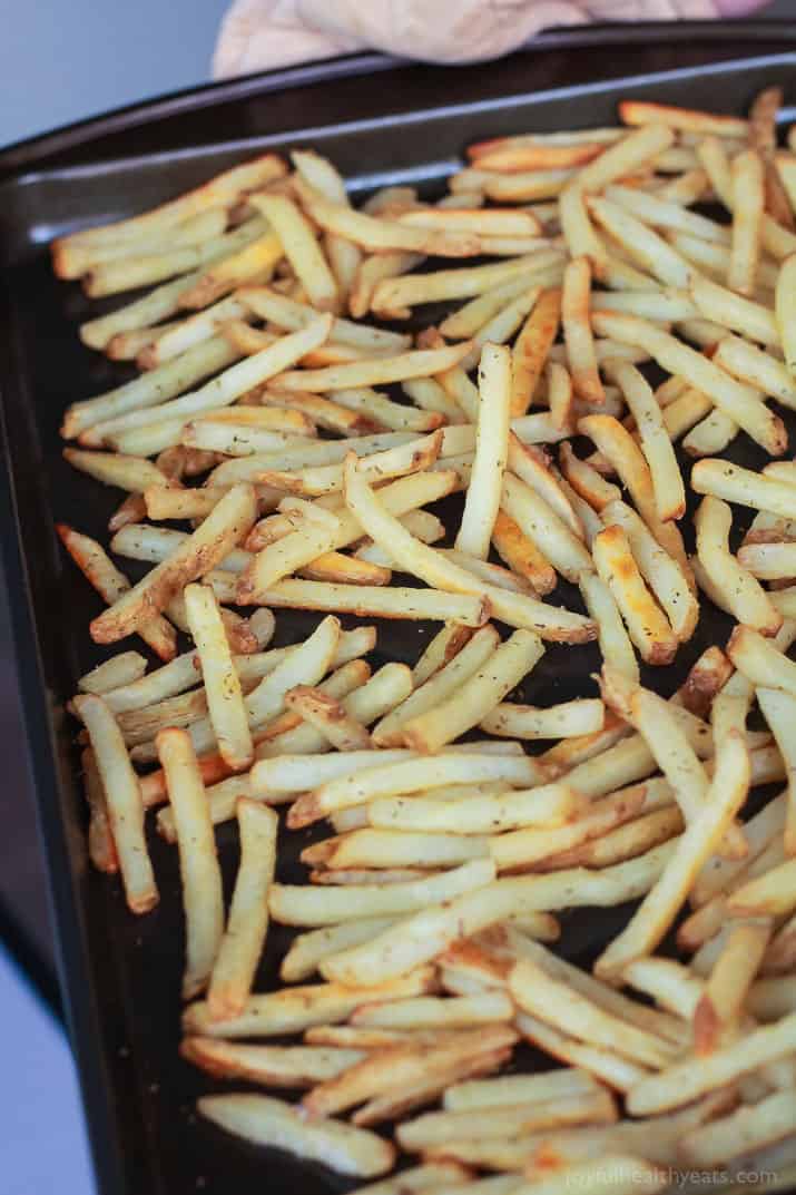 Skinny Greek Loaded French Fry Nachos, an easy creative appetizer recipe that will wow your guests and only takes 25 minutes to make! Filled with homemade tzatziki sauce, ground lamb, and fresh vegetables! | joyfulhealthyeats.com #recipes #SpringIntoFlavor #ad