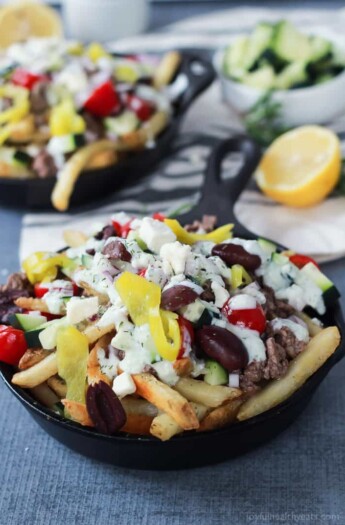 Skinny Greek Loaded French Fry Nachos, an easy creative appetizer recipe that will wow your guests and only takes 25 minutes to make! Filled with homemade tzatziki sauce, ground lamb, and fresh vegetables! | joyfulhealthyeats.com #recipes #SpringIntoFlavor #ad