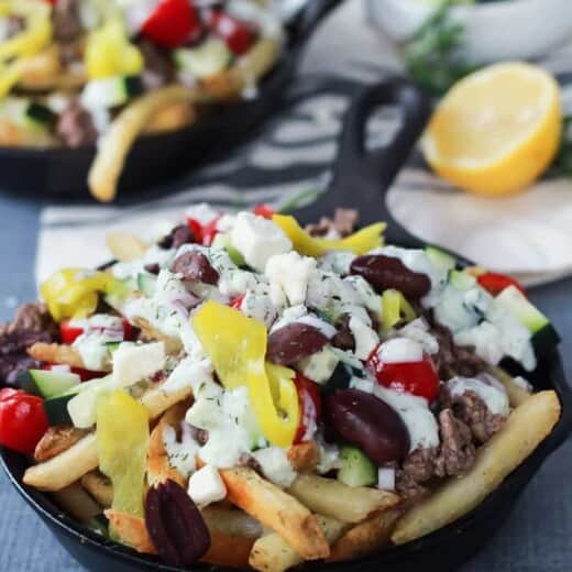 Skinny Greek Loaded French Fry Nachos, an easy creative appetizer recipe that will wow your guests and only takes 25 minutes to make! Filled with homemade tzatziki sauce, ground lamb, and fresh vegetables! | joyfulhealthyeats.com #recipes #SpringIntoFlavor #ad