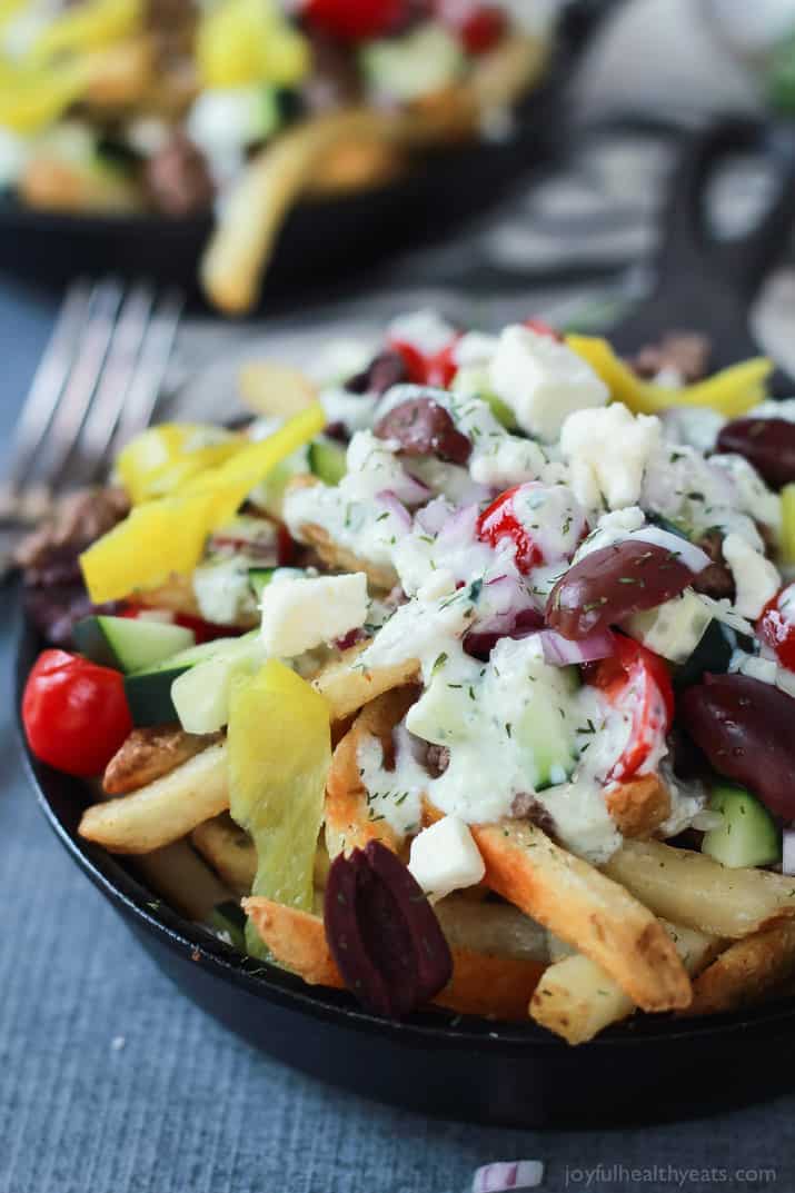 Skinny Greek Loaded French Fry Nachos, an easy creative appetizer recipe that will wow your guests and only takes 25 minutes to make! Filled with homemade tzatziki sauce, ground lamb, and fresh vegetables! | joyfulhealthyeats.com #recipes #SpringIntoFlavor #ad