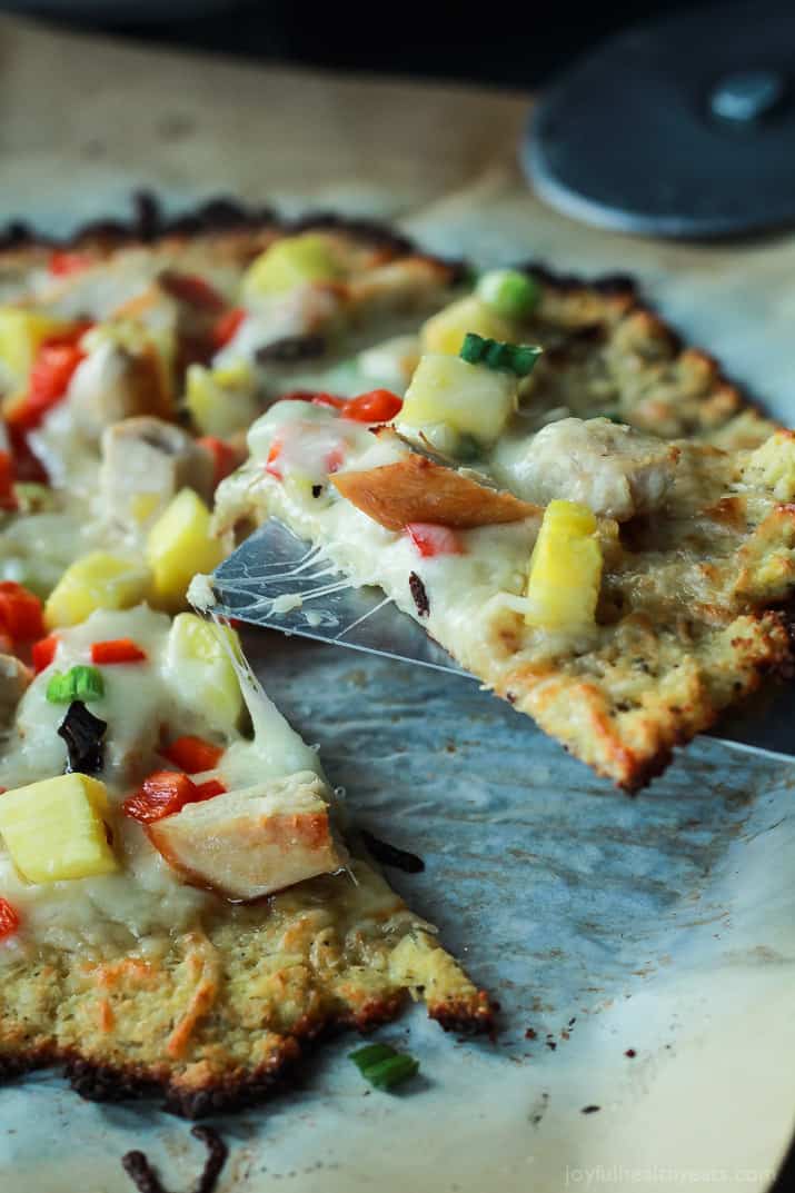 Thai Chili Chicken Pizza with a Cauliflower Crust, topped with a Sweet Spicy Thai Chili Sauce, fresh pineapple, bell peppers, and chicken. An easy gluten free pizza recipe that will be on your table in 25 minutes! | joyfulhealthyeats.com #recipes 