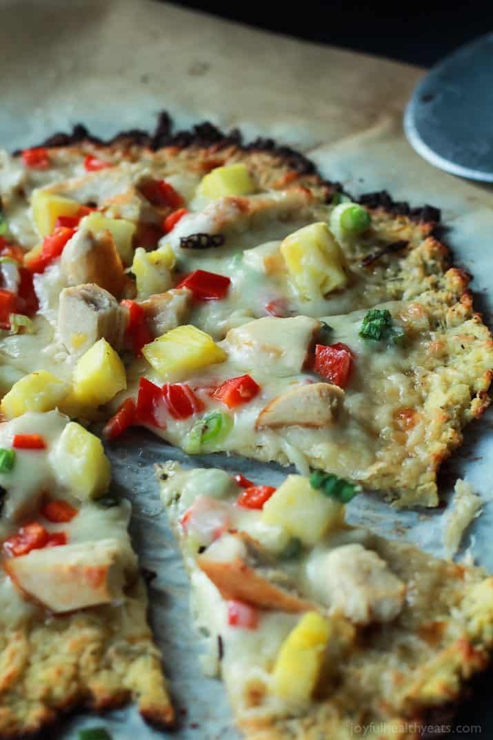 Thai Chili Chicken Pizza with a Cauliflower Crust, topped with a Sweet Spicy Thai Chili Sauce, fresh pineapple, bell peppers, and chicken. An easy gluten free pizza recipe that will be on your table in 25 minutes! | joyfulhealthyeats.com #recipes