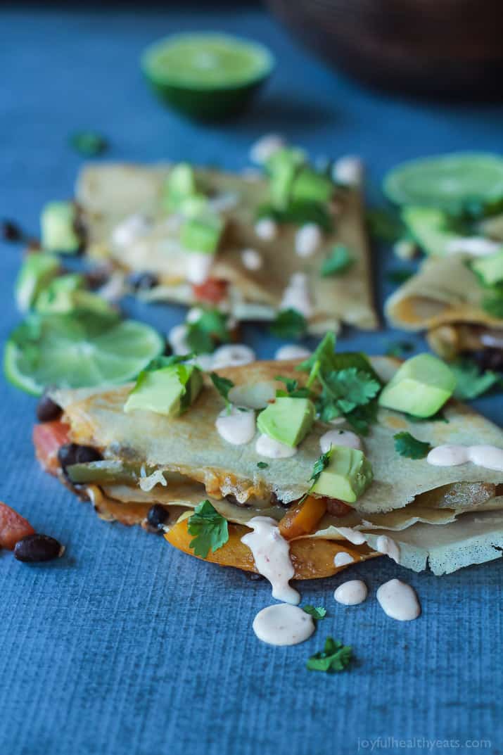 Easy Tex-Mex Vegetarian Crepe Quesadillas filled with fresh corn, bell peppers, black beans, and onions then topped with a drizzle of Chipotle Lime Crema! An appetizer that is to die for! | joyfulhealthyeats.com #recipes