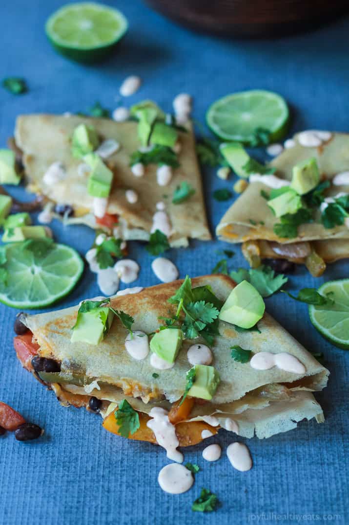 Easy Tex-Mex Vegetarian Crepe Quesadillas filled with fresh corn, bell peppers, black beans, and onions then topped with a drizzle of Chipotle Lime Crema! An appetizer that is to die for! | joyfulhealthyeats.com #recipes