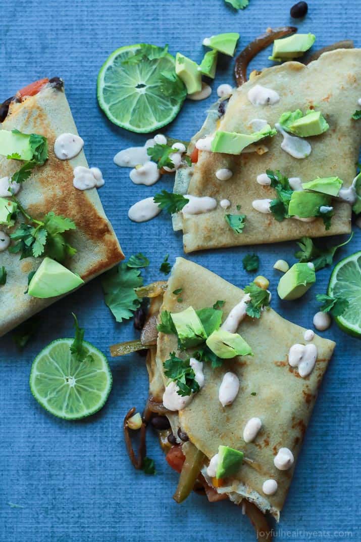 Easy Tex-Mex Vegetarian Crepe Quesadillas filled with fresh corn, bell peppers, black beans, and onions then topped with a drizzle of Chipotle Lime Crema! An appetizer that is to die for! | joyfulhealthyeats.com #recipes