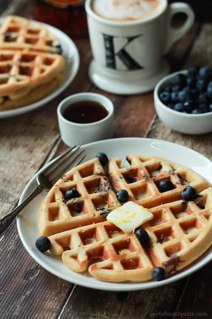 Whole Wheat Lemon Blueberry Waffles, these Waffles are packed with juicy blueberries and fresh lemon zest for the perfect light summer breakfast recipe! | joyfulhealthyeats.com #brunch #mothersday