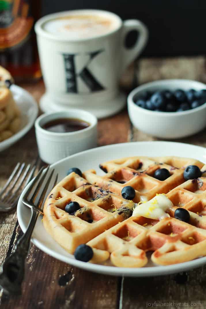 Whole Wheat Lemon Blueberry Waffles, these Waffles are packed with juicy blueberries and fresh lemon zest for the perfect light summer breakfast recipe! | joyfulhealthyeats.com #brunch #mothersday