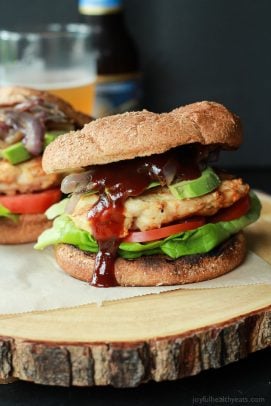 A juicy BBQ Chicken Burger topped with sweet Caramelized Onions, drizzled with savory BBQ Sauce, and creamy avocado. A grilling must try this summer! | joyfulhealthyeats.com #recipes