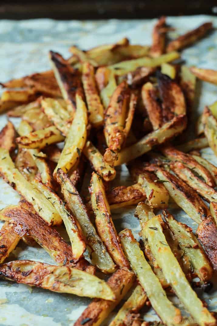 Crispy Baked Garlic Parmesan Fries on parchment paper