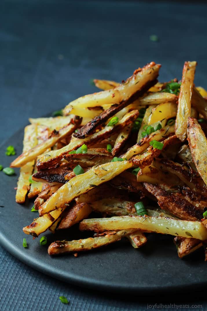 Crispy Baked Garlic Parmesan Fries with scallions piled on a plate