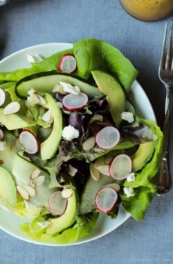A simple fresh Summer salad that takes 5 minutes - Avocado Butter Lettuce Salad filled with spicy radishes, almond slices, goat cheese, and topped with a Lemon Vinaigrette. | joyfulhealthyeats.com #recipe #glutenfree #vegetarian