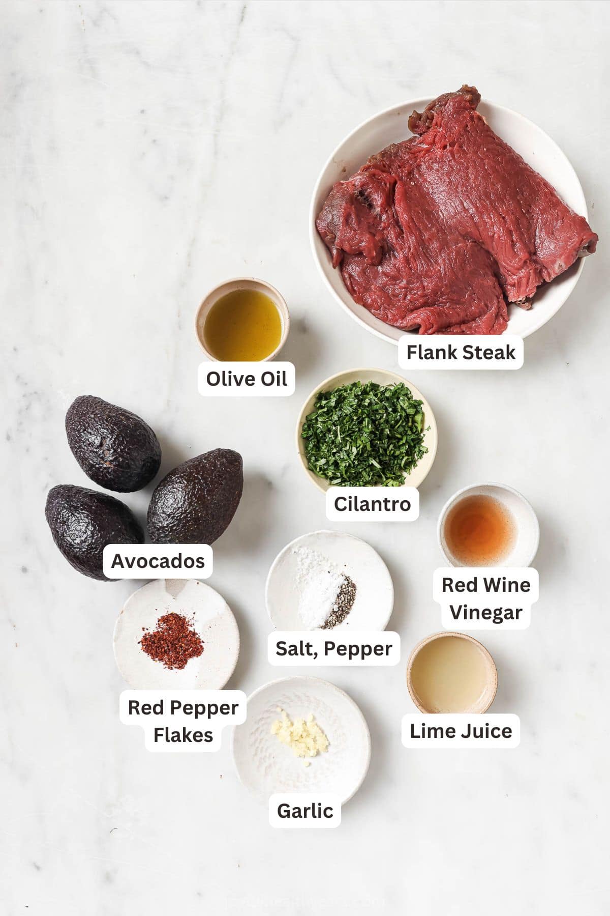 This juicy Grilled Flank Steak with Avocado Chimichurri is an easy recipe that’s full of flavor. It’s ready in less than 20 minutes! Overhead view of ingredients for grilled flank steak with avocado chimichurri