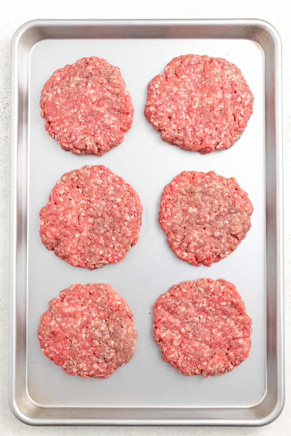 Formed patties on a baking sheet. 