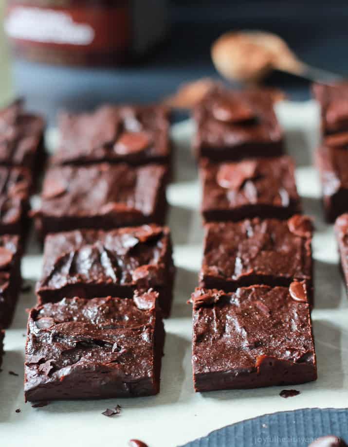 Fudgy Avocado Brownies on parchment cut into squares