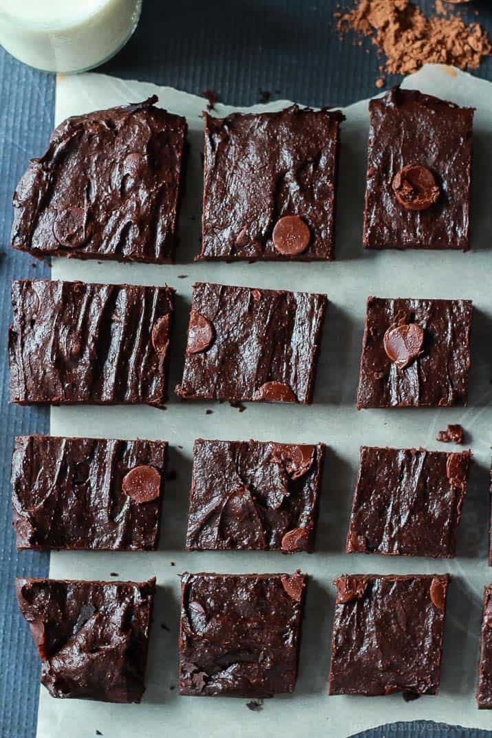 Top view of Fudgy Avocado Brownies on parchment cut into squares