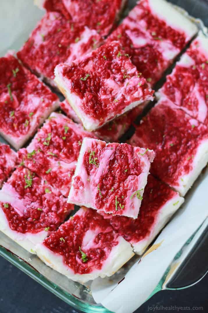 Skinny Raspberry Mojito Cheesecake Bars filled with creamy cheesecake goodness, fresh mint and lime juice, then topped with a fresh raspberry compote - only 130 calories! Perfect for summer parties! | joyfulhealthyeats.com #RaspberryDessert #Driscollsberry #ad