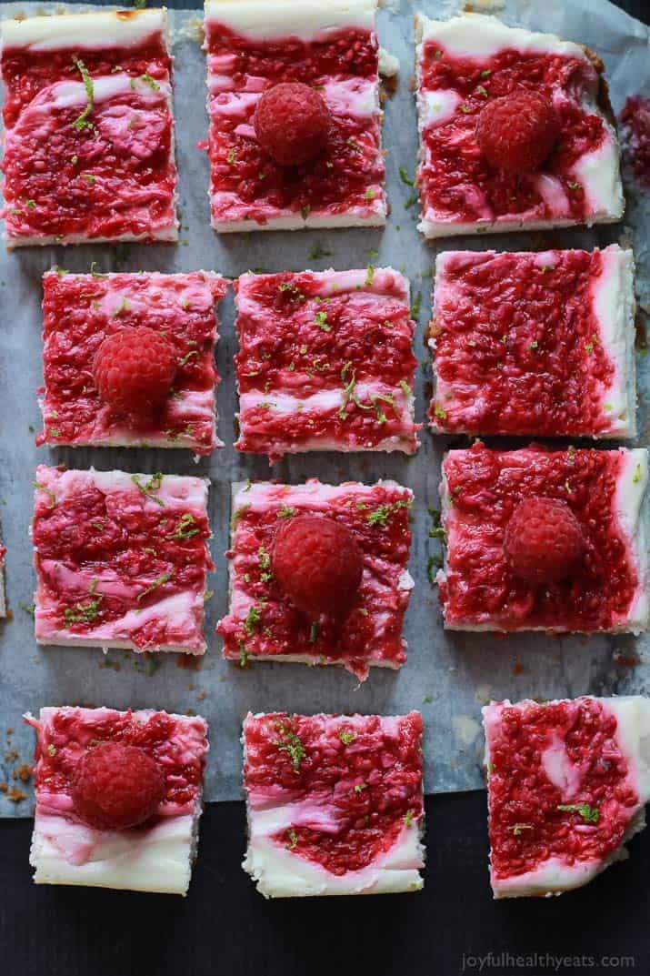 Skinny Raspberry Mojito Cheesecake Bars filled with creamy cheesecake goodness, fresh mint and lime juice, then topped with a fresh raspberry compote - only 130 calories! Perfect for summer parties! | joyfulhealthyeats.com #RaspberryDessert #Driscollsberry #ad