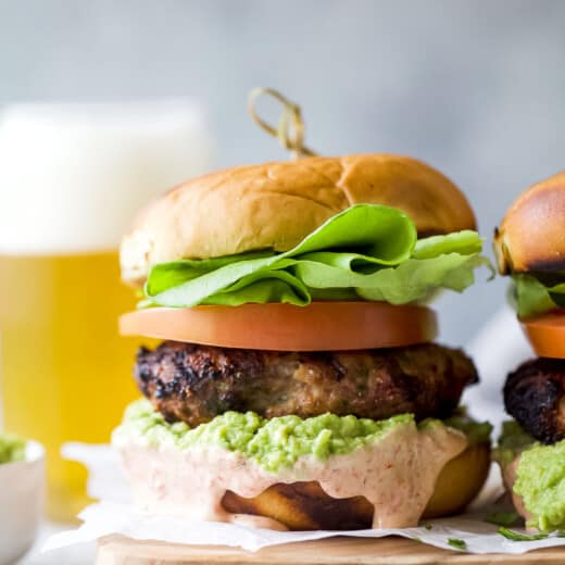 Assembled turkey burgers with spicy mayo and guacamole.