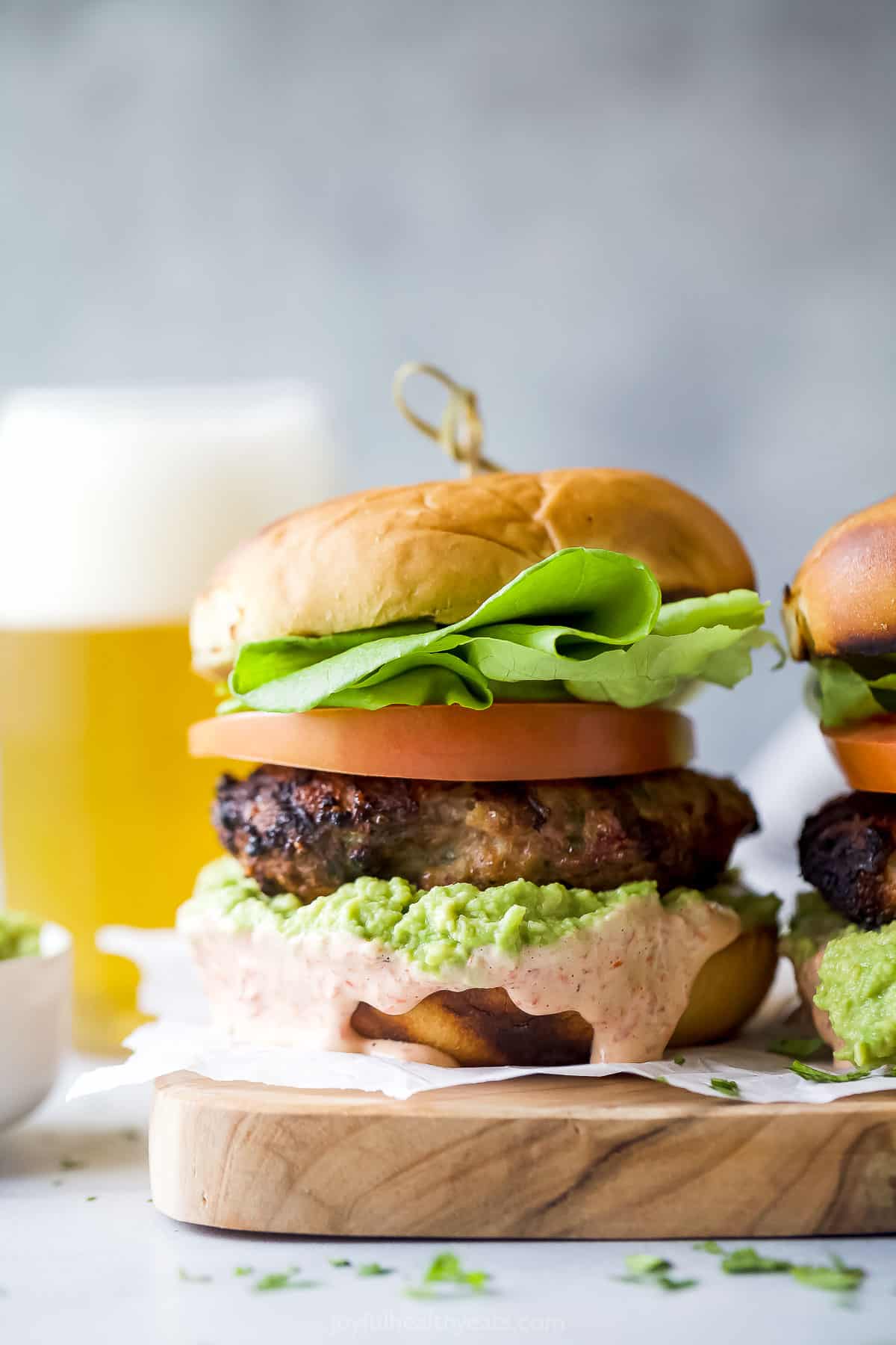 Assembled turkey burgers with spicy mayo and guacamole. 