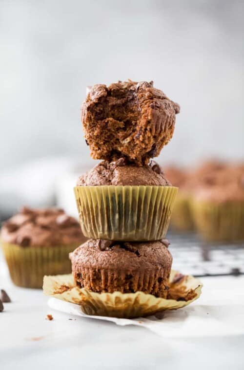 skinny double chocolate banana muffins stacked in a tower