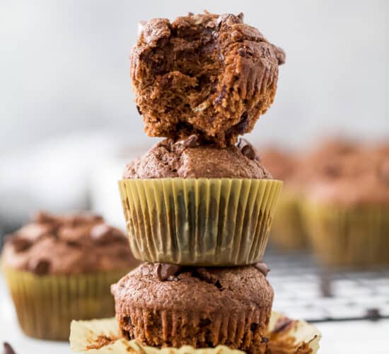 skinny double chocolate banana muffins stacked in a tower